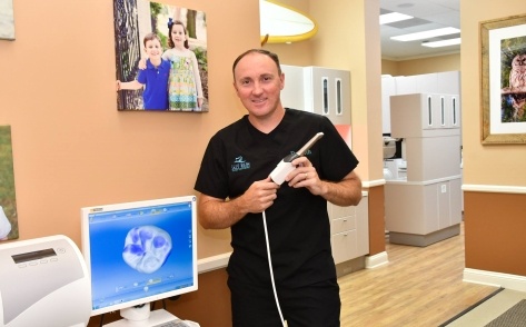 Dentist holding 3 D smile scanning system