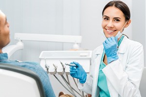 Dentist smiling at patient's dental exam