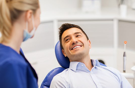 Man smiles at dentist